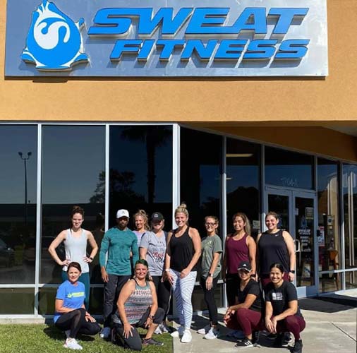 Sweat Fitness Clients Working Out